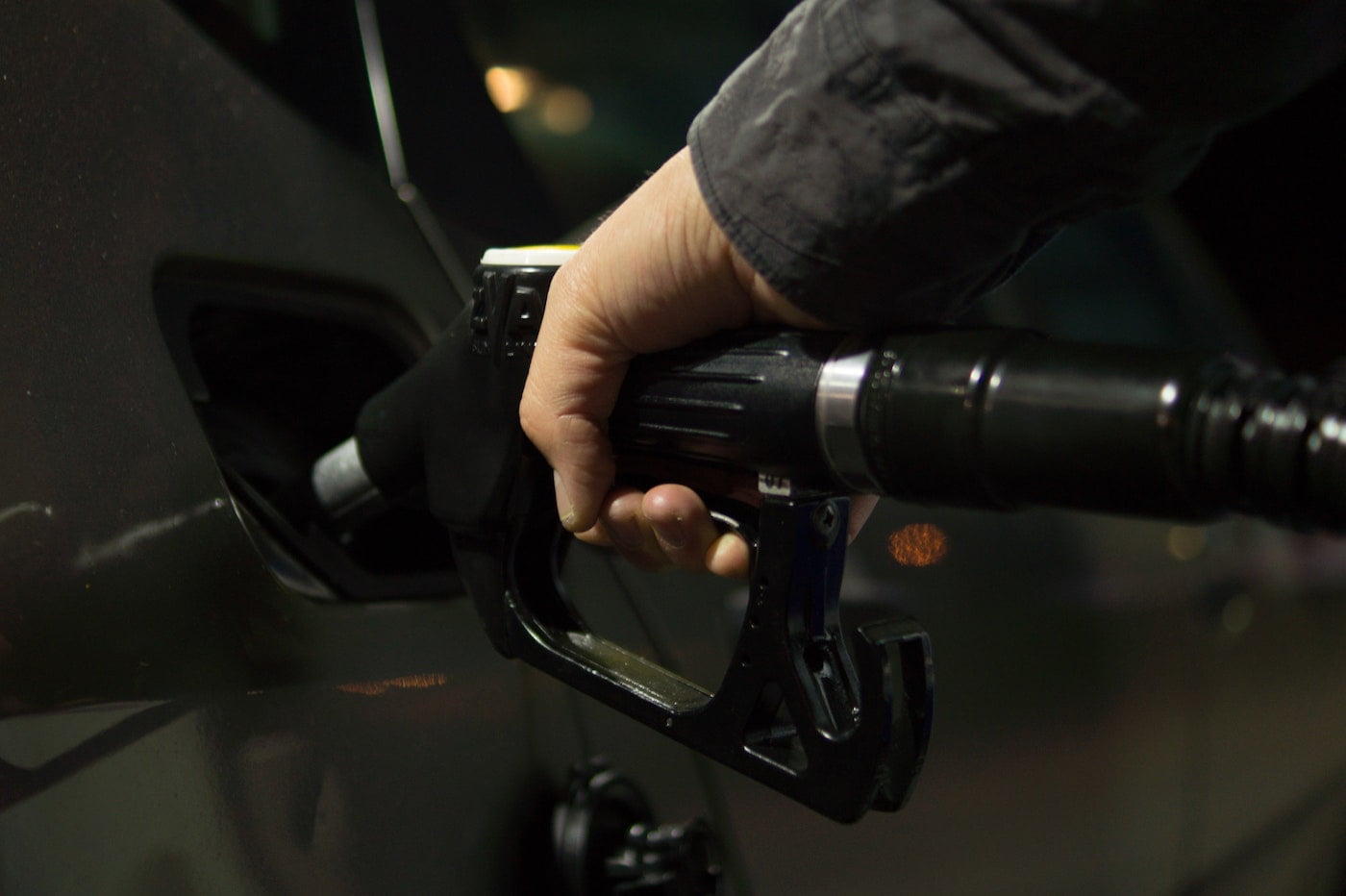 a hand holding a petrol pump